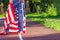 Woman with a flag of United States of America in the hands, outdoors