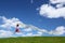 Woman flies on sky with piece of fabric in hands