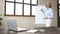 Woman with a flip chart in front of laptop