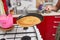 Woman flipping pancake in the pan