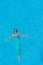 Woman floating above pool water