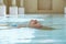 Woman Floating In Swimming Pool