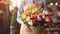 Woman florist holding in her hands a beautiful bouquet of various fresh flowers for sale