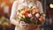 Woman florist holding in her hands a beautiful bouquet of various fresh flowers for sale