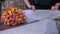 Woman florist is packaging bouquet of roses in craft paper in flower shop.