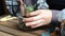 The woman florist plants succulent to a wooden flowerpot. close-up. angle view