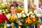 Woman florist selling sunflowers bouquet flower shop