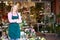 Woman florist standing outside shop