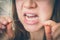 Woman flossing teeth with dental floss - retro style