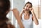 Woman Flossing Teeth With Tooth Floss Standing In Bathroom Indoor