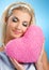 Woman with fluffy heart pillow