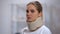 Woman in foam cervical collar, health insurance, accident victim, medical clinic