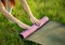 Woman fold up mat after yoga workout close up in the park Healthy life