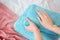 Woman folding clean towels on bed