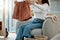 Woman folding a pair of shorts. Woman relaxing at home cleaning clothing. Woman sitting in a chair folding laundry