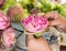 Woman folding petal pink lotus for pray Buddha in thai