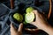 Woman folds the fruits of Osage Orange Maclura pomifera in the basket. Maclura use in alternative medicine