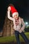 Woman fooling around with Santa hat near Leaning Tower of Pisa