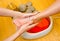 Woman foot in paraffin bath at the spa