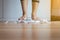 Woman foot standing on weigh scales with tape measure in foreground,Weight loss