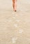 Woman footprints on the beach sand leading away