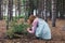 Woman foraging in forest