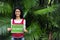 Woman in the forest holding a go green sign