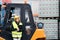 Woman forklift truck driver in an industrial area.