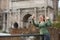 Woman in foro romano takes photos with her smartphone