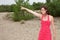 Woman forties wearing red and white sixties dress pointing away finger