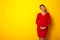 Woman forty years in a dress on a yellow background