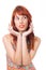 Woman frames her face with her hands. Female model. Redhead girl