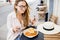 Woman with francesinha meal in Porto city