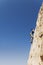 Woman Free Climbing On Cliff