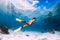 Woman freediver swimming over with yellow fins in ocean. Freediving or snorkeling in Mauritius