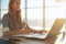 Woman freelancer female hands with pen writing on notebook at home or office