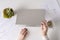 Woman freelancer finishing working and closes laptop with empty drink up cup of coffee and the end of working day. graphics