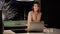 A woman freelancer at home in the kitchen is having a romantic call on a laptop