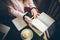 Woman freelancer leafing through pages of a diary in a coffee shop. Entrepreneur working in cafe. Business woman uses paper