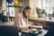 Woman freelancer leafing through pages of a diary in a coffee shop. Entrepreneur working in cafe. Business woman uses paper