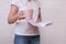 Woman freelancer standing with a big cup of coffee and a notebook in hands in the morning and planning her day, reading