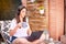 Woman freelancer, travel blogger works on a laptop. sitting on a lounger in the garden