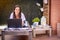 Woman freelancer, travel blogger works on a laptop. sitting on a lounger in the garden