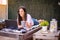 Woman freelancer, travel blogger works on a laptop. sitting on a lounger in the garden