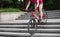 Woman freerider riding down city stairs