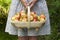 Woman with fresh apples in a wooden trug