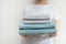 Woman with fresh towel in laundry room interior