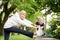 woman friend athlete stretching her leg outdoor together