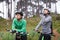 Woman, friends and drinking water in nature with bicycle for cycling, fitness or break on off road trail or path