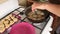 Woman fries cookies in a pan. Removes the lid, flips the cookie. Ready puts on a plate. Timelapse